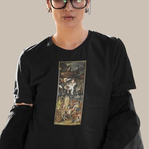 May include: A black t-shirt with a graphic print of a painting depicting a scene of chaos and mayhem. The painting is framed in a gold frame.