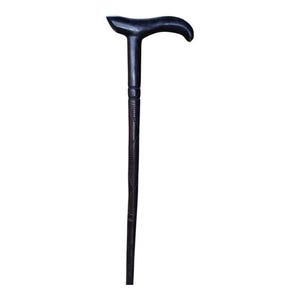 May include: A dark brown wooden cane with a curved handle. The handle is smooth and rounded, while the shaft has a textured, ridged design. The cane is approximately 36 inches long.