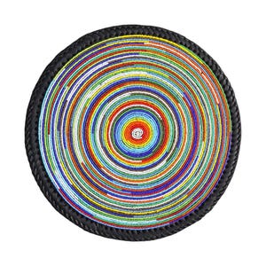 May include: A circular beaded tray with a black braided border. The centre has a spiral pattern of colourful beads in red, yellow, blue, green, and white. The tray is displayed against a white backdrop.