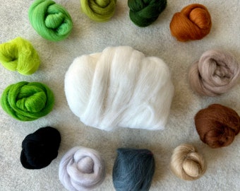May include: A large central mass of white wool roving surrounded by twelve smaller, circular bundles of wool in various colors including lime green, olive, forest green, rust orange, beige, brown, charcoal gray, light gray, and black.