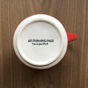 May include: A set of three ceramic mugs with a speckled, matte finish. The mugs are in shades of cream, light gray, and dark gray. Each mug has a simple, minimalist design, perfect for coffee or tea.