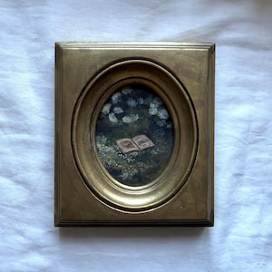 Guazzo originale con cornice | Libro d'epoca nell'erba, dipinto romantico di campagna, cornice dorata, arte nostalgica letteraria, regalo unico per gli amanti dei libri