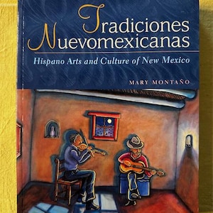 May include: A book titled "Tradiciones Nuevomexicanas" with the subtitle "Hispano Arts and Culture of New Mexico" by Mary Montaño. The cover art depicts two musicians playing instruments in a room with a window.