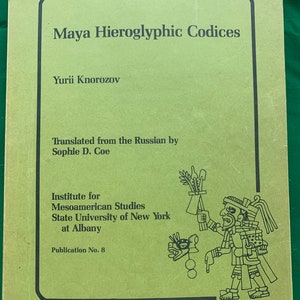 May include: A book titled "Maya Hieroglyphic Codices" by Yurii Knorozov, translated by Sophie D. Coe. The cover is light green with black text and a drawing of a Mayan figure. Published by the Institute for Mesoamerican Studies.