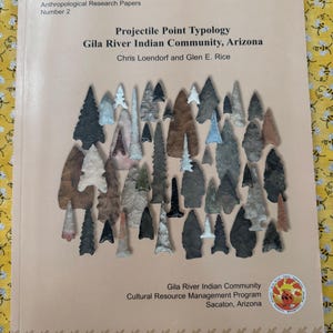 May include: A book titled "Projectile Point Typology" featuring various projectile points. The cover includes text: "Gila River Indian Community, Arizona" and "Chris Loendorf and Glen E. Rice." The book is part of the "Anthropological Research Papers" series.