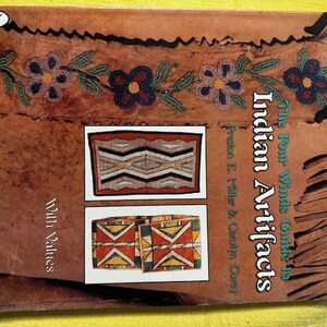 May include: A book titled "The Four Winds Guide to Indian Artifacts" by Preston E. Miller and Carolyn Corey. The cover features images of Native American artifacts and floral beadwork. The book is published by Schiffer.