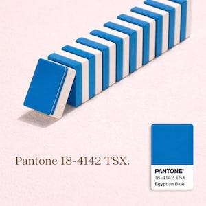 May include: A row of blue and white dominoes, with one domino slightly tilted. The image includes the text "Pantone 18-4142 TSX" and a color swatch labeled "PANTONE&reg; 18-4142 TSX Egyptian Blue."