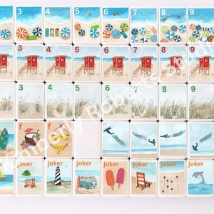 May include: A collection of illustrated tiles featuring beach scenes. Each tile depicts elements like umbrellas, lifeguard stations, seagulls, and beach accessories. Some tiles have the word "joker" at the bottom. The color palette includes blues, reds, and yellows.