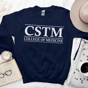 May include: A navy blue sweatshirt with the text "CSTN College of Medicine" in white.