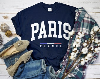 May include: A navy blue t-shirt with white text that reads "PARIS FRANCE" with the French flag in between the words.