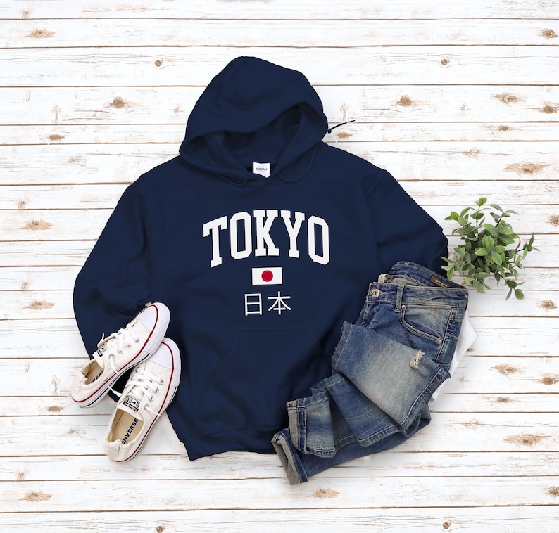 May include: Navy blue hooded sweatshirt with white text that says "TOKYO" and a Japanese flag with the text "日本" underneath.
