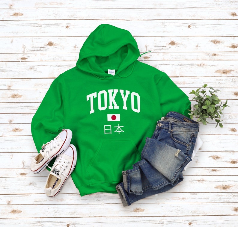 May include: Green hooded sweatshirt with white text that says "TOKYO" and a Japanese flag with the text "日本" underneath.