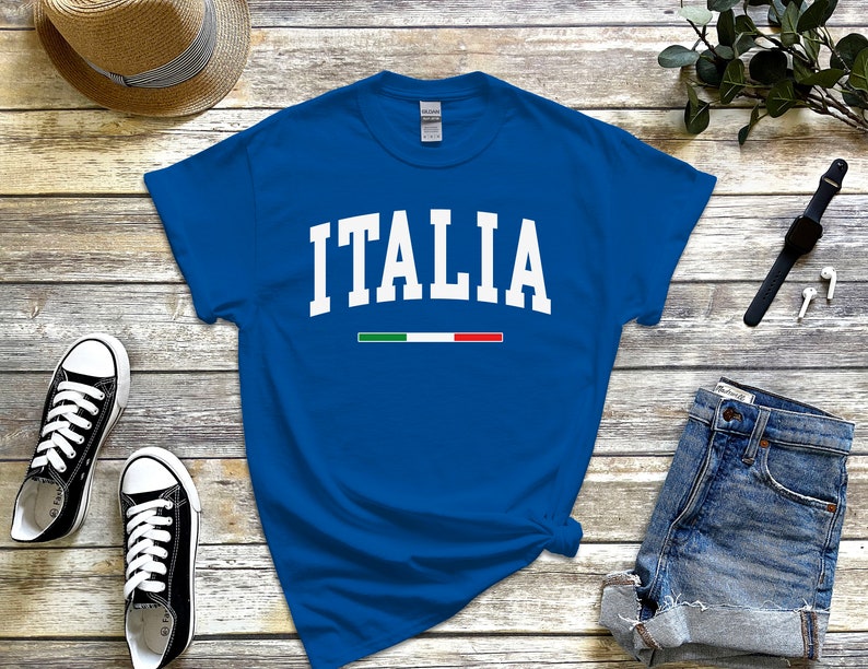 May include: A royal blue t-shirt with white text that reads "ITALIA" and a small green, white, and red stripe underneath.