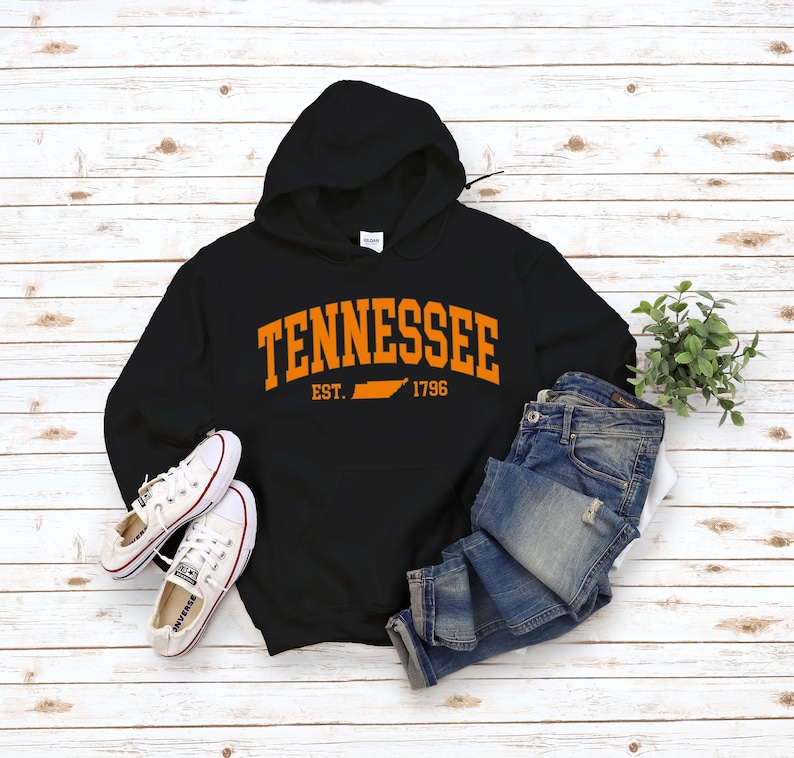 May include: Black hooded sweatshirt with an orange graphic print of the state of Tennessee and the text "Tennessee Est. 1796".