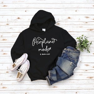 May include: Black hoodie with white text that says "Airplane mode" and a small airplane icon. The text also includes "Maldives 2019".