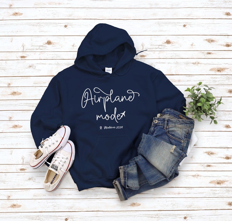 May include: A navy blue hoodie with a white graphic that says "Airplane mode" with a small airplane icon and the text "Maldives 2029".