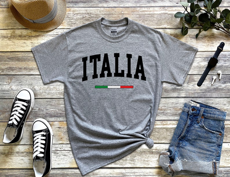 May include: Gray t-shirt with the word "ITALIA" in black block letters and a green, white, and red stripe underneath.