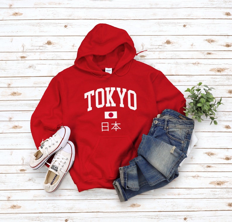 May include: Red hooded sweatshirt with white text that says "TOKYO" and a Japanese flag with the text "日本" underneath.