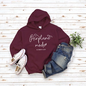 May include: Burgundy hoodie with a white graphic that says "Airplane mode" and "Maldives 2019".