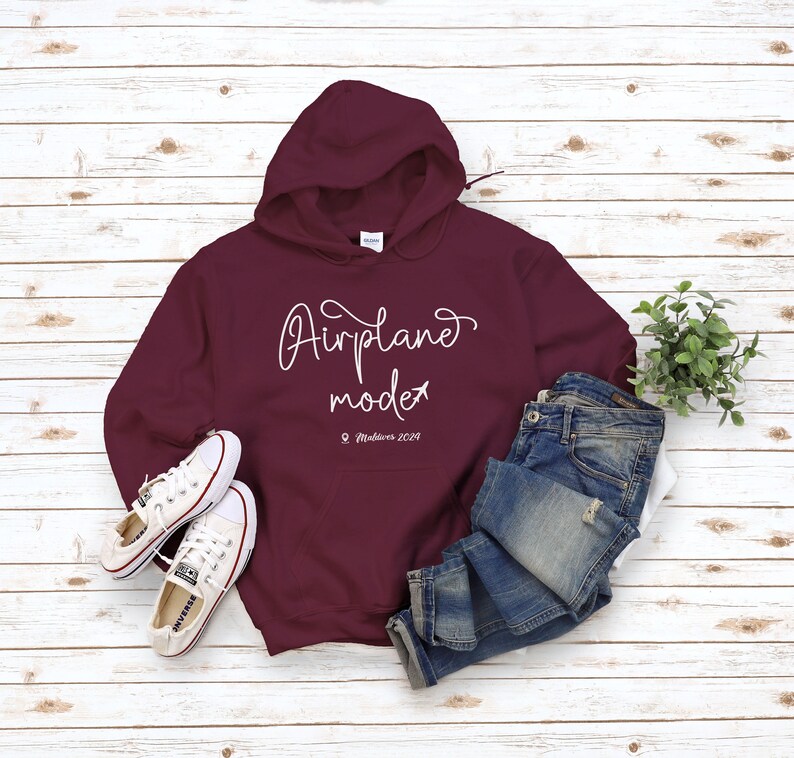 May include: Burgundy hoodie with a white graphic that says "Airplane mode" and "Maldives 2019".
