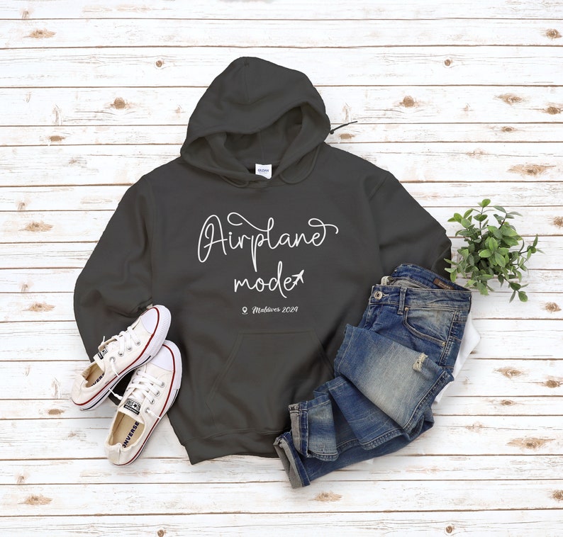 May include: A dark gray hooded sweatshirt with the text "Airplane mode" and a small airplane icon. The text "Maldives 2019" is written below the main text.