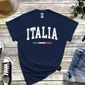 May include: A navy blue t-shirt with the word "ITALIA" in white text and the Italian flag colors in a thin stripe below the word.