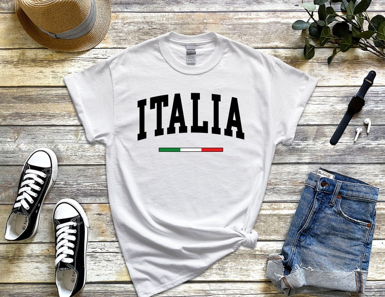 May include: White t-shirt with black text that says "ITALIA" and a green, white, and red stripe underneath.