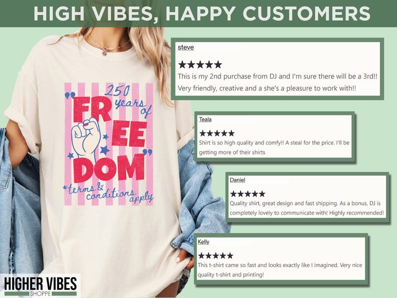May include: Cream-colored t-shirt with a graphic that reads "250 years of Freedom" in red and blue, with a raised fist and stars. The text "terms & conditions apply" is below the main text. The shirt is from Higher Vibes Shoppe.