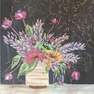 May include: An acrylic painting of a floral arrangement in a cream-coloured vase. The bouquet features pink, yellow, and purple flowers with green leaves. The background is black with a gold floral pattern. The painting is on a white and grey surface.