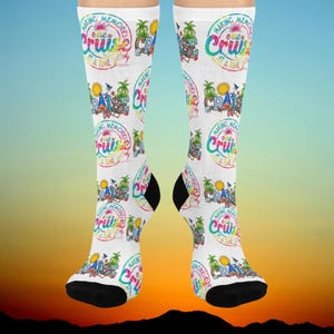 May include: A pair of white socks with a colourful design featuring the text "Making Memories One Cruise At A Time".