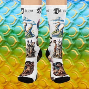 May include: White socks with black heels and toes, featuring dragon and castle illustrations. The socks have the word "Dtoes" printed on the top. The background is a colourful, textured pattern.