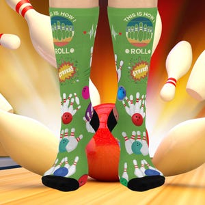 May include: Green knee-high socks with a bowling theme. The socks feature bowling pins, balls, and the text "This is how I roll" and "Strike!". The socks have black heels and toes, and a red bowling ball is visible.