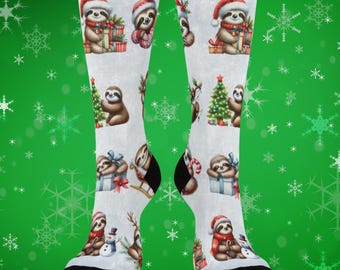 May include: White socks with a repeating pattern of sloths wearing Santa hats and scarves, holding gifts, and near Christmas trees and snowmen. The socks have black heels and toes.