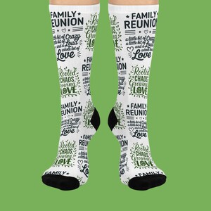 May include: White knee-high socks with black heels and toes. The socks are printed with the words "Family Reunion", "Rooted in Chaos, Growing Love", and other phrases in a green script font.