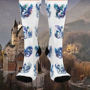 May include: White socks with a blue and purple watercolour dragon design. The socks feature multiple dragons in different poses.