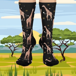 May include: Black knee-high socks featuring a repeating pattern of giraffes in shades of brown and tan. The socks have a black background with small white dots and diagonal lines. The socks are shown against a backdrop of an African savanna scene.