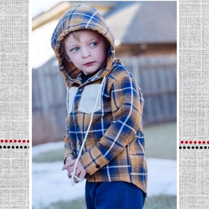 May include: A young child wearing a yellow and blue plaid hooded shirt with a white drawstring. The shirt has a patch pocket on the chest. The child is standing in front of a blurred background. The text "Everett's Hooded Shirt" is below the image.