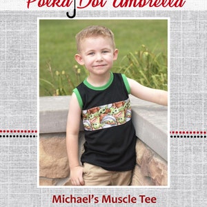 Op de afbeelding: Een zwart spier shirt zonder mouwen met een groene rand aan de halslijn en een band van groene stof met een herhaald patroon van een cartoonfiguur. De tekst "Michael's Muscle Tee" is onder de afbeelding gedrukt.