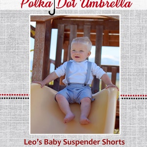 May include: A baby boy wearing a white shirt and blue suspender shorts with a polka dot pattern sits on a yellow slide. The image is framed with a black and white polka dot umbrella and the text "Polka Dot Umbrella" and "Leo's Baby Suspender Shorts".
