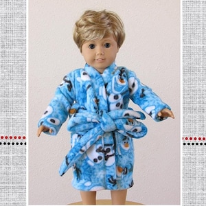 May include: A blue fleece robe with a snowman pattern for a doll. The robe has a tie belt and is called "Stephen's Comfy Robe".