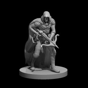 May include: A gray miniature figurine of a hooded figure holding a crossbow. The figure is wearing a long hooded cloak and has a determined expression on their face.
