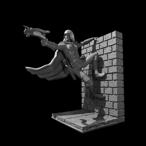 May include: A gray figurine of a person in a cape and holding a weapon, leaping over a brick wall. The figurine is posed in a dynamic action pose.