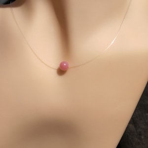 Invisible Rhodochrosite solitaire bead necklace. Minimalist natural stone. Nylon thread. Fine stone. Birthstone. Elegant gift.
