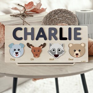 a picture of a wooden name board with animals on it