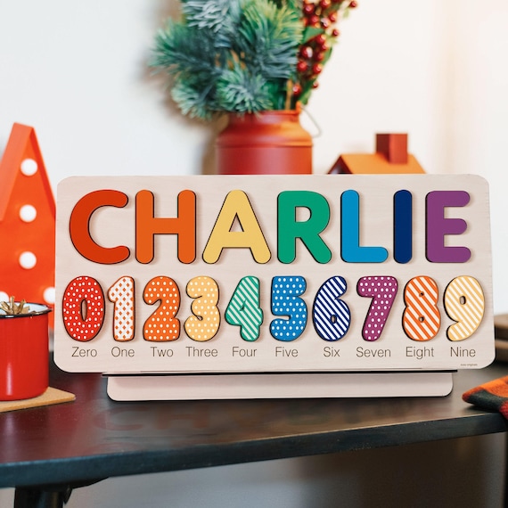 A wooden name puzzle where each letter is a chunky character — kids learn to spell their own name while playing, and 41 favorites confirm parents love it.
