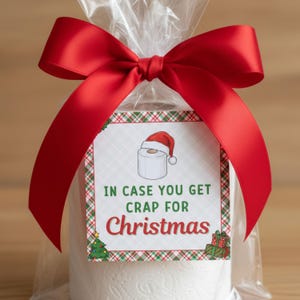 May include: A roll of white toilet paper wrapped in cellophane and tied with a large red satin bow. A gift tag features a cartoon toilet paper roll wearing a Santa hat, with the text "IN CASE YOU GET CRAP FOR Christmas."