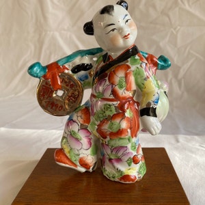 RARE Vintage Chinese Boy Famille Rose-Floral Robe Porcelain Figurine Carrying Gold Coin & Longevity Peach Symbolic of Long Life + Wealth 7&quot;