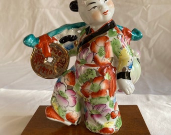 RARE Vintage Chinese Boy Famille Rose-Floral Robe Porcelain Figurine Carrying Gold Coin & Longevity Peach Symbolic of Long Life + Wealth 7&quot;