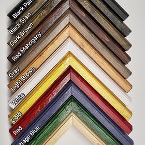 May include: A variety of wood picture frames in different colors, including black, brown, red, white, gold, green, and blue. The frames are arranged in a diagonal line, with the gloss finish on the left and the matte finish on the right. The text "Shadow Box Picture Frame" is visible at the bottom of the image.