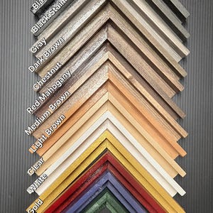 May include: A display of thin border floating frame samples in various colors and finishes. The samples include gloss and matte finishes, with colors like black, gray, brown, red, gold, and green. The text "Thin Border Floating Frame" is visible.